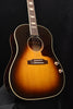 Sunburst acoustic-electric guitar with pickguard, bridge pickup, and dot inlays