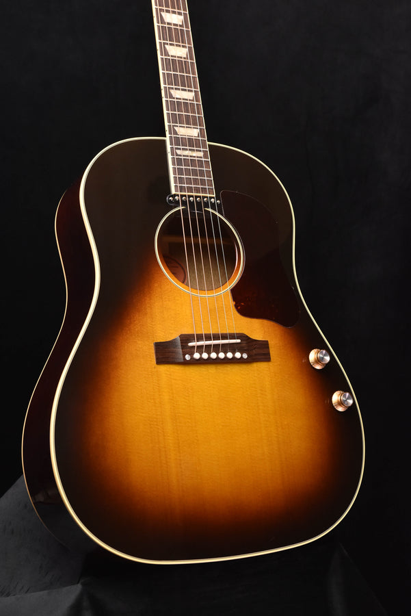 Sunburst acoustic-electric guitar with pickguard, bridge pickup, and dot inlays