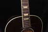 Fretboard and headstock of sunburst acoustic-electric guitar with dot inlays