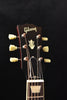 Gibson-branded acoustic-electric guitar headstock with cream tuning keys