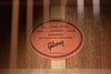 Acoustic guitar warranty label on wooden back