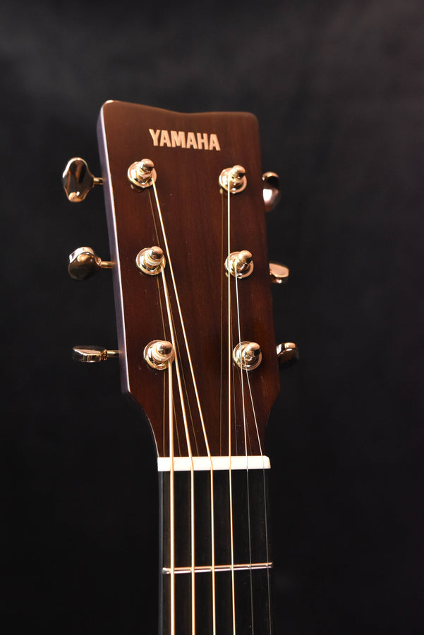 Yamaha headstock of acoustic guitar with gold tuning machines