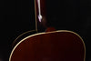 Brown acoustic-electric guitar top with arched cutaway near the soundhole