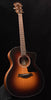 Sunburst acoustic guitar with soundhole rosette, bridge, and six strings.