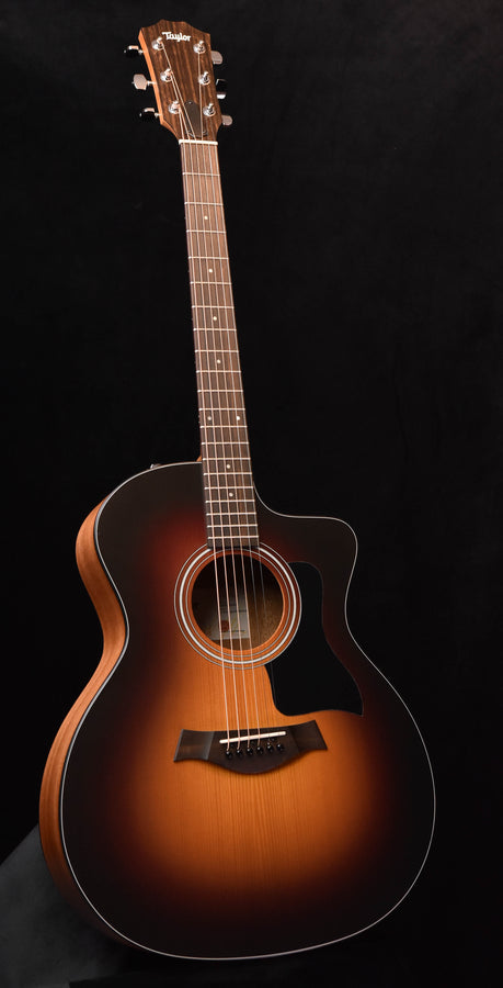 Sunburst acoustic guitar with soundhole rosette, bridge, and six strings.