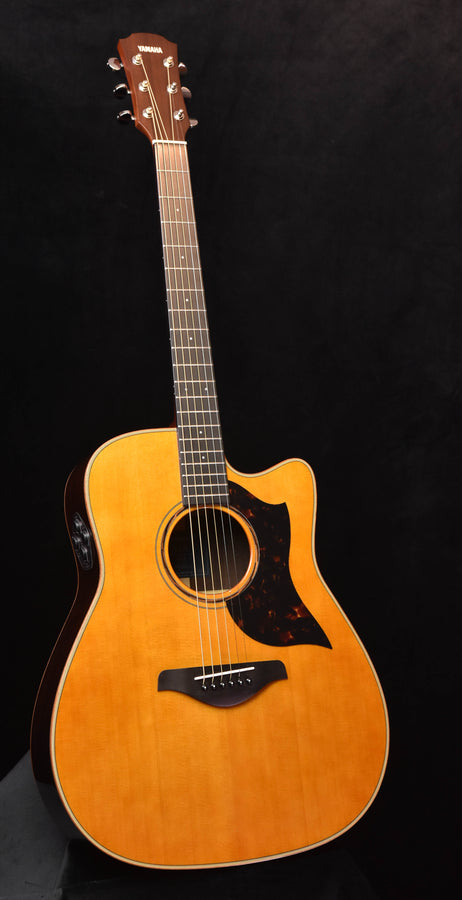 Yamaha A3R acoustic/electric guitar with natural wood body and black pickguard