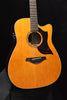 Natural acoustic/electric guitar, round soundhole and pickup/pickguard detail visible
