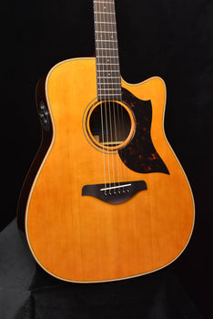 natural acoustic/electric guitar, round soundhole and pickup/pickguard detail visible