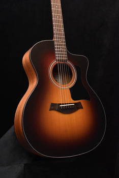 sunburst acoustic guitar front view with soundhole rosette and bridge.