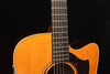 Close-up of the guitar neck and fretboard with the round soundhole in frame