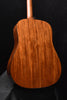 Gloss dreadnought acoustic guitar back view with rich wood grain pattern