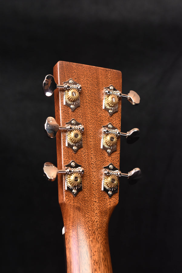 Dreadnought acoustic guitar headstock close-up with chrome tuning pegs