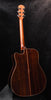 Acoustic/electric guitar with natural finish, full body and tortoise-style pickguard