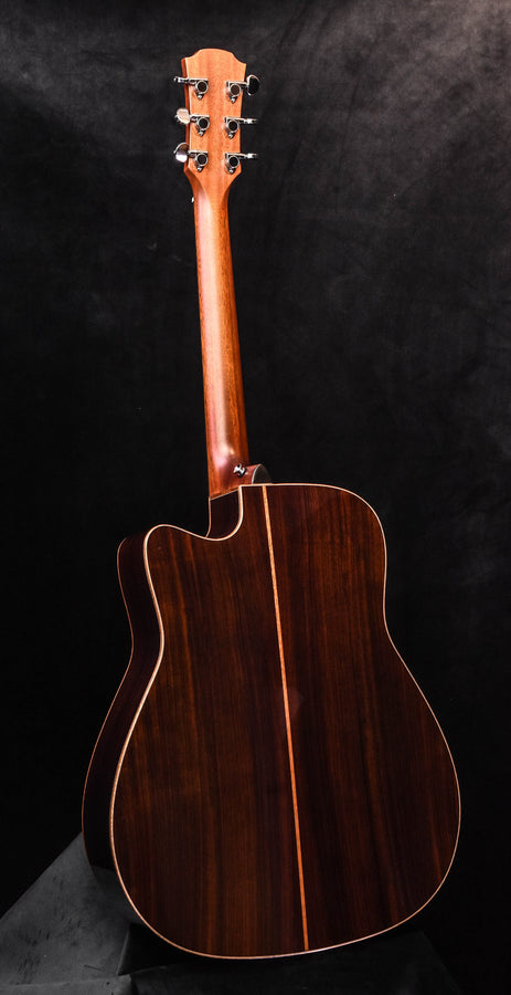 Acoustic/electric guitar with natural finish, full body and tortoise-style pickguard