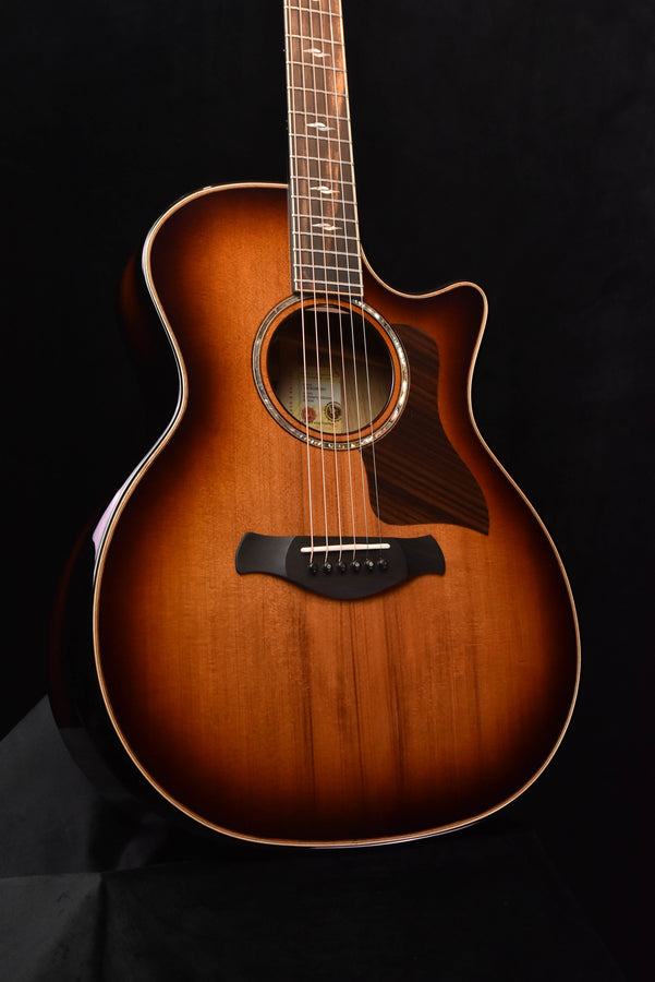 Red-brown acoustic guitar with rosette sound hole and black bridge