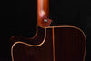 Side view of acoustic/electric guitar body showing neck joint and dark edge binding