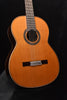 Classical guitar in natural wood with rosette sound hole and fixed bridge.