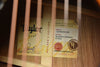 Acoustic guitar inside labels on the wood body near the soundhole