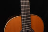Classical guitar fretboard and upper neck section, viewed close-up.