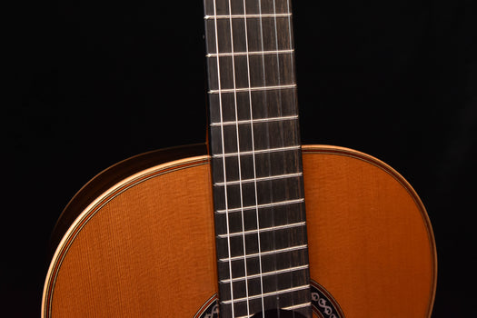 classical guitar fretboard and upper neck section, viewed close-up.