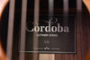 Cordoba Luthier Series C12 label on headstock, with decorative emblem.