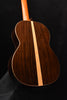 Classical guitar back view with dark wood grain and central light strip detail.