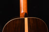 Classical guitar top edge near neck joint, showing dark wood finish.
