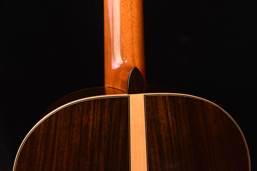 classical guitar top edge near neck joint, showing dark wood finish.