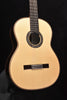 Light wood classical acoustic guitar front view with rosette sound hole and bridge