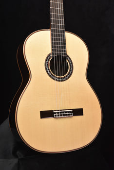 light wood classical acoustic guitar front view with rosette sound hole and bridge