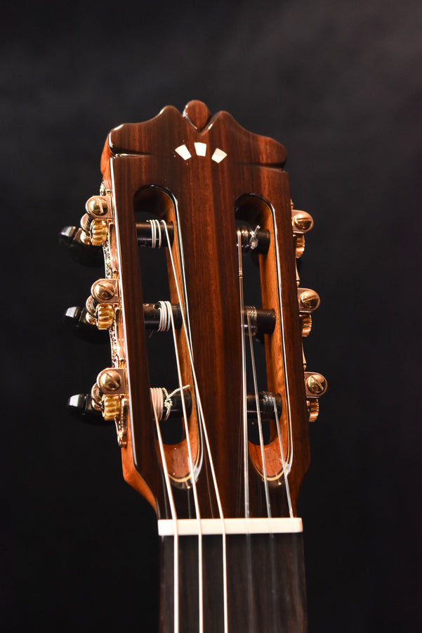Cordoba classical guitar headstock with tuning machines and wood-grain finish