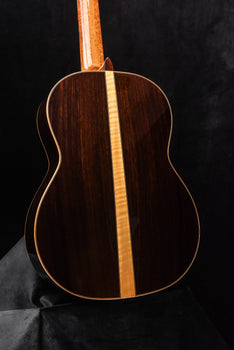 dark wood classical acoustic guitar back with light center seam