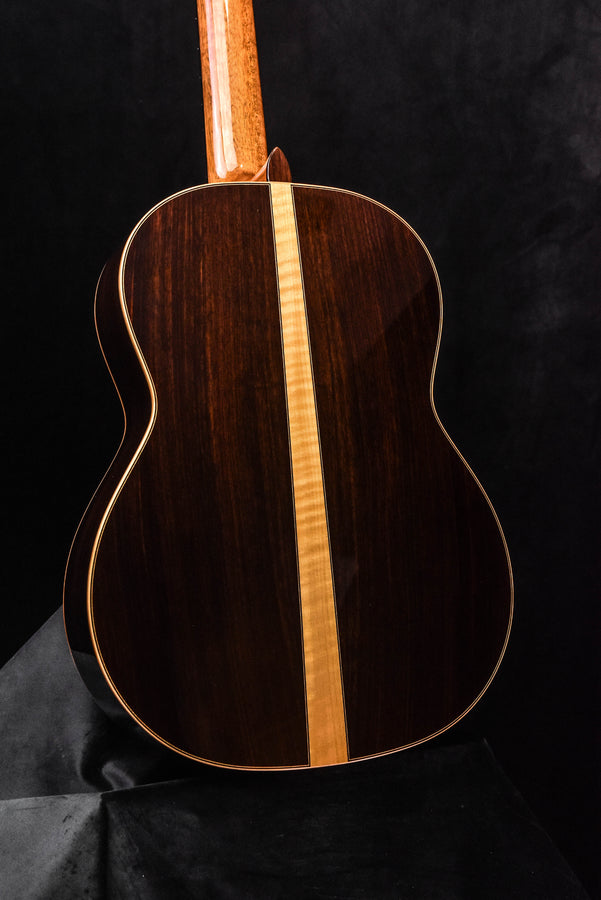 Dark wood classical acoustic guitar back with light center seam