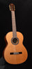 Classical acoustic guitar with natural wood finish and rosette sound hole