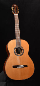 classical acoustic guitar with natural wood finish and rosette sound hole
