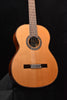 Classical acoustic guitar in natural wood, rosette sound hole and bridge visible