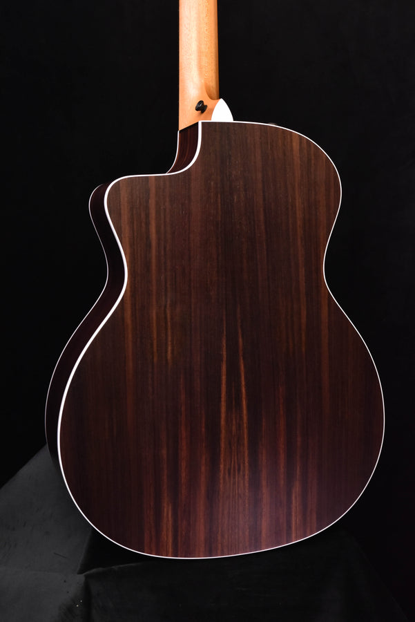 Acoustic guitar body side with dark wood grain and white binding