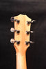 Acoustic guitar headstock with six tuning machines and natural wood top