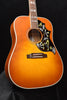 Cherry sunburst dreadnought acoustic guitar front with hummingbird pickguard and rosette
