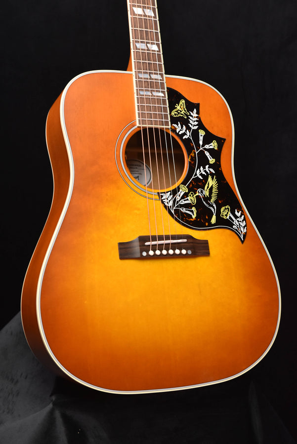 Cherry sunburst dreadnought acoustic guitar front with hummingbird pickguard and rosette