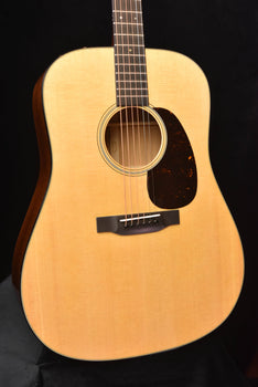 front view acoustic guitar with round soundhole and dark pickguard