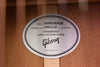 Round Hummingbird style label on the guitar body with guaranteed quality text