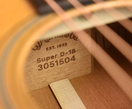 headstock label with serial text and “super d-18” marking
