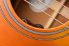 Acoustic guitar controls with black vol and tone knobs on an orange finish top