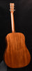 Back of acoustic guitar with warm brown wood grain and neck