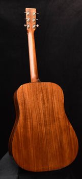 back of acoustic guitar with warm brown wood grain and neck