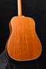 Dreadnought acoustic guitar back in warm wood tone with white edge binding