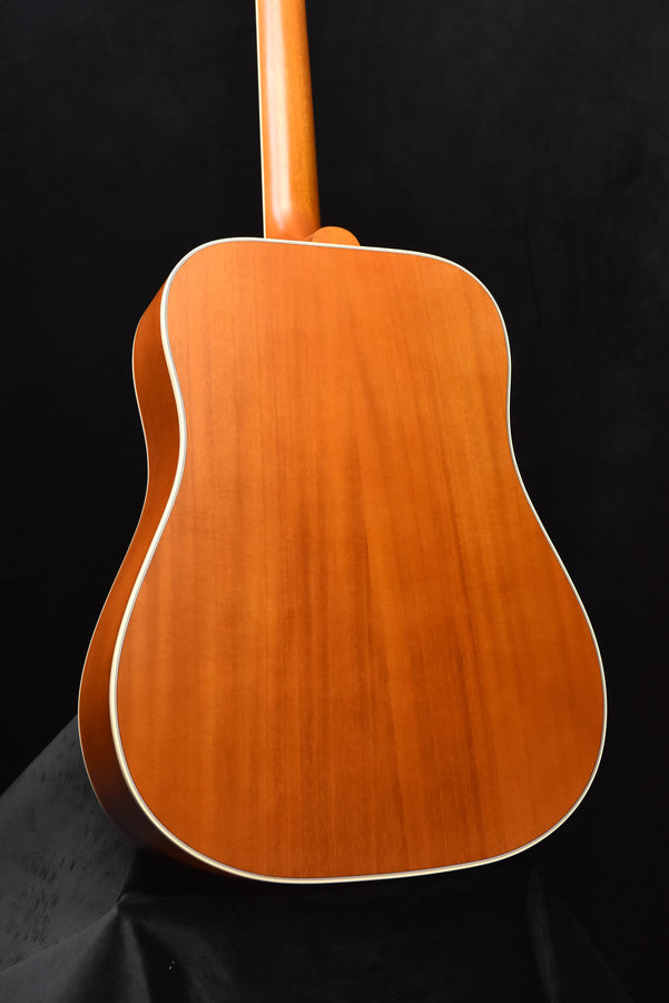 Dreadnought acoustic guitar back in warm wood tone with white edge binding