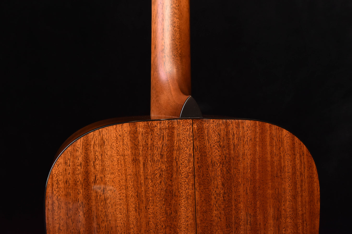 Acoustic guitar top area with bridge and wood grain