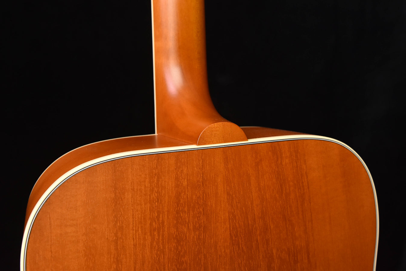 Acoustic guitar neck joint and top section with glossy wood grain